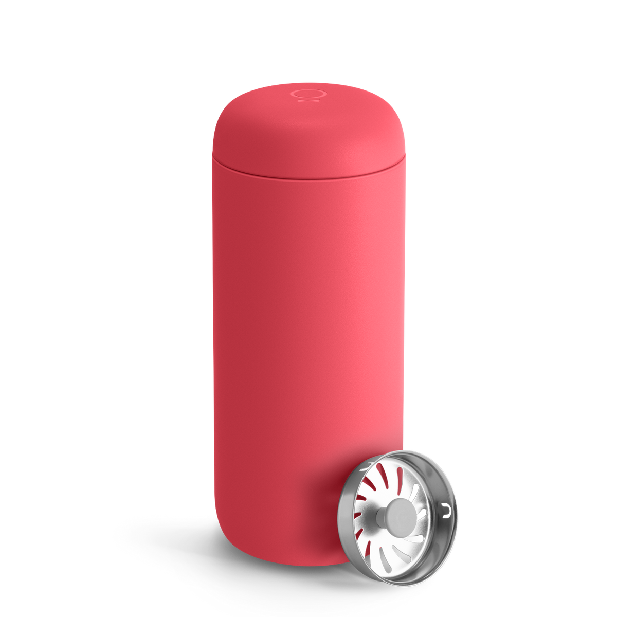 A Coral Crush Fellow Carter Move Mug with a removable metal filter cap placed beside it.